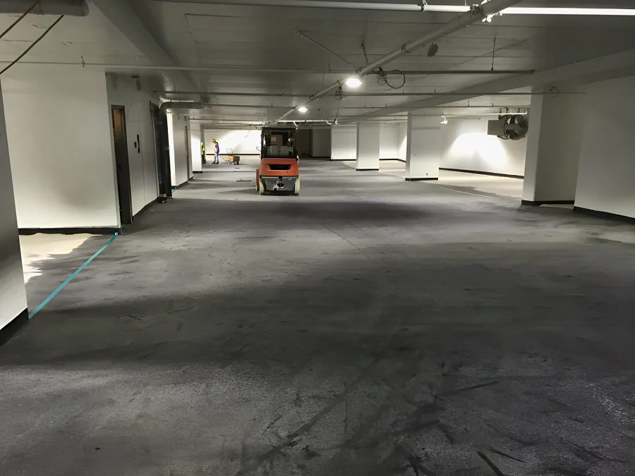 The Kelmar system going down bay by bay in the 980 Howe Street parkade, the next section still bare beyond the tape line