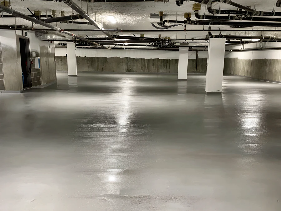 Grey Tremco traffic coating across an underground parking level in Abbotsford, between white columns