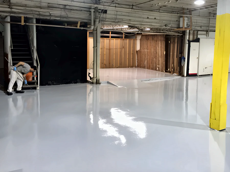 Crew rolling the coating by the stair at the Adventure Den dog daycare in Vancouver