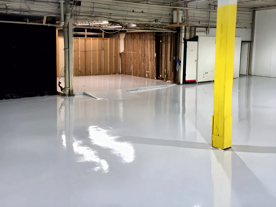 Glossy light grey epoxy and urethane floor through the Adventure Den dog daycare in Vancouver, from the stair to the rooms still being framed