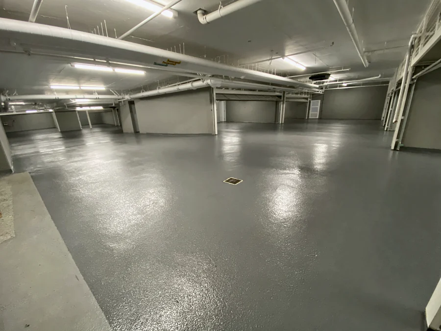 A finished parking level with a sheen round a floor drain in the 2289 Bellevue Avenue parkade, West Vancouver
