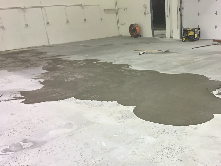 Concrete repair spread across a warehouse slab in Burnaby before shot blasting and coating