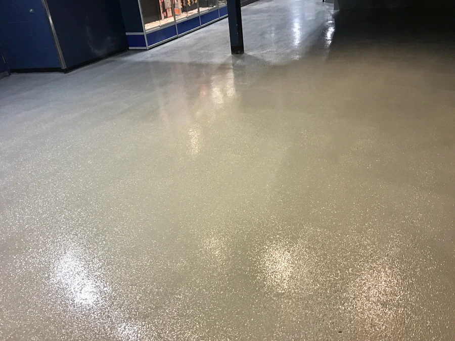 The finished anti-slip epoxy floor through the concourse at Canlan Ice Sports in Burnaby, glossy under the lights