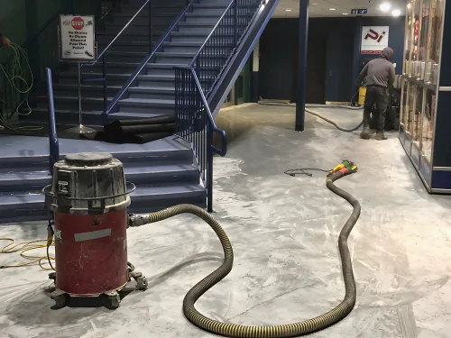 The concourse at Canlan Ice Sports in Burnaby being ground under dust extraction before the epoxy