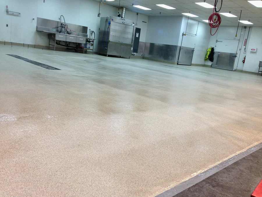 The finished cementitious urethane and decorative quartz floor laid to the trench drains at Costco Abbotsford