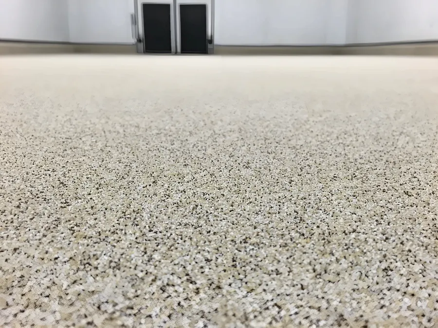 Close view of the decorative quartz finish at Costco Kamloops, cream, tan and brown grains across the floor