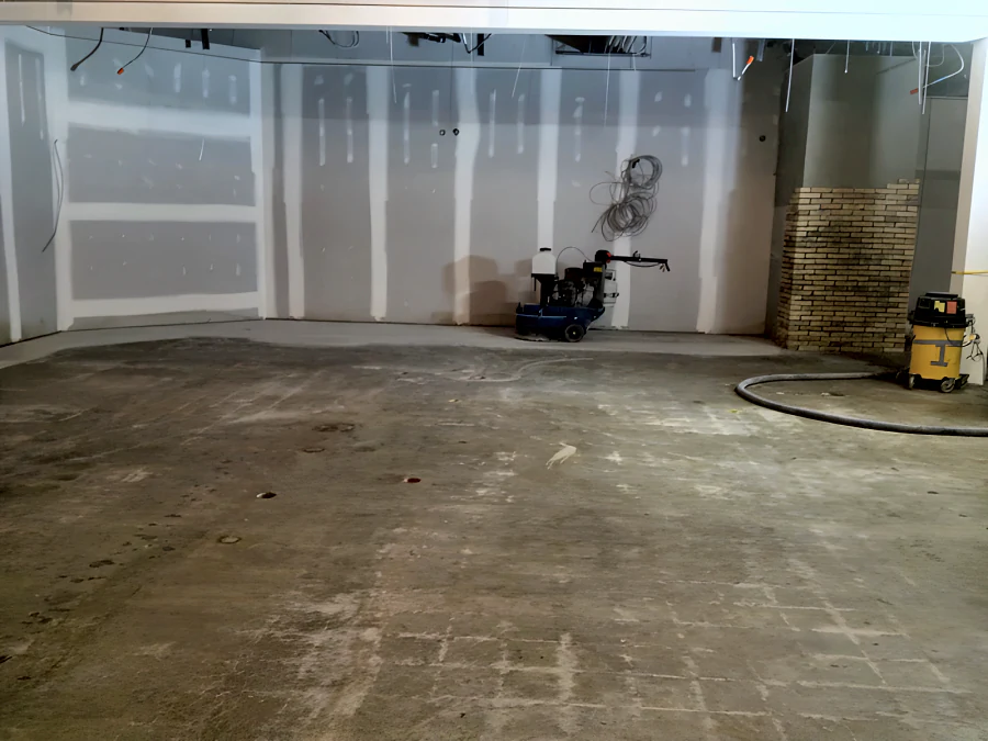 The Fresh St. Market slab in West Vancouver ground back to clean concrete, with the grinder parked against the wall