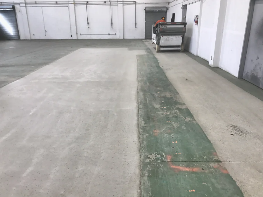 An old green floor coating being shot blasted off the slab of a commercial space in Grandview, Vancouver, 2017