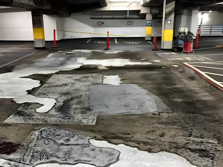 The Vancouver RCPM/ICBC parkade before resurfacing: patched, delaminating concrete across the bay