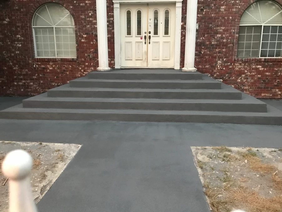 The finished front stairs and walkway in the dark grey ResinTech EWS quartz floor