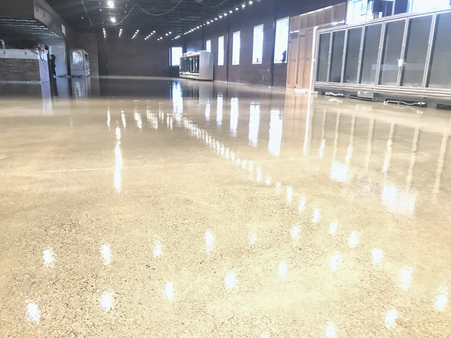 The finished clear-coated floor along the coolers and the windows