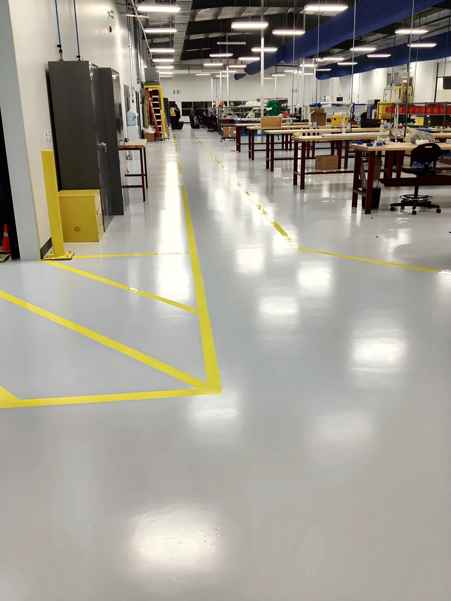 Yellow bay line marking over the finished floor at MTU Canada