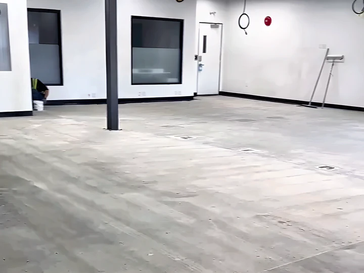 The Lush manufacturing floor before resurfacing: bare, worn grey concrete