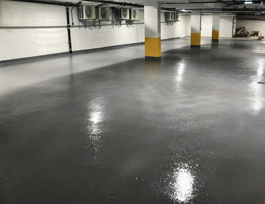 The finished Tremco Vulkem 350NF/950NF/950NF traffic coating across the parking level, round the yellow-banded columns, 2017