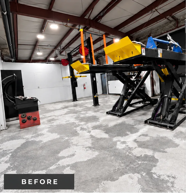 Mazda Richmond Automall service shop before coating: bare, stained and patchy concrete around a scissor hoist