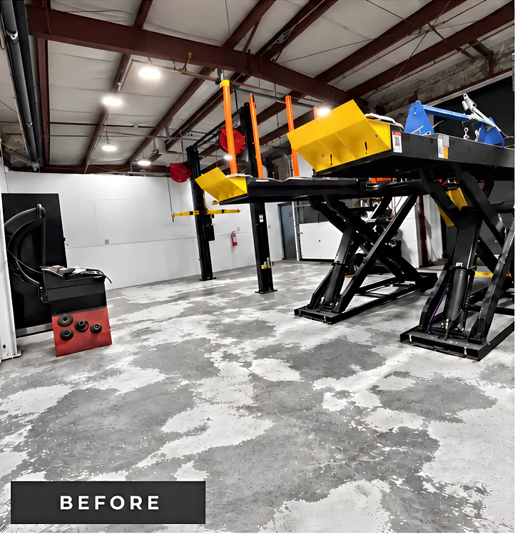 Mazda Richmond Automall service shop before coating: bare, stained and patchy concrete around a scissor hoist