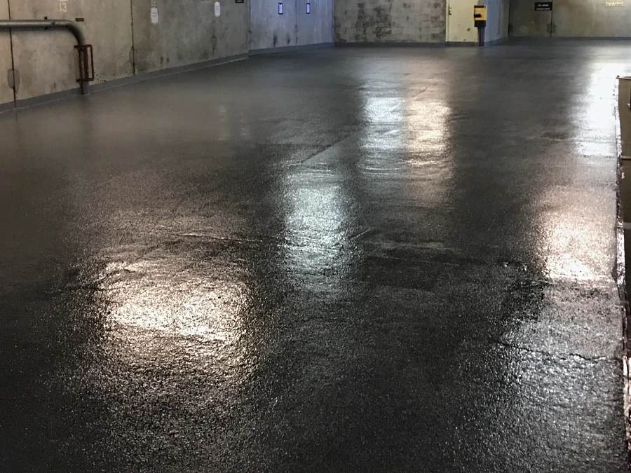 A North Vancouver parkade level with the fresh Tremco Vulkem coat, glossy under the lights