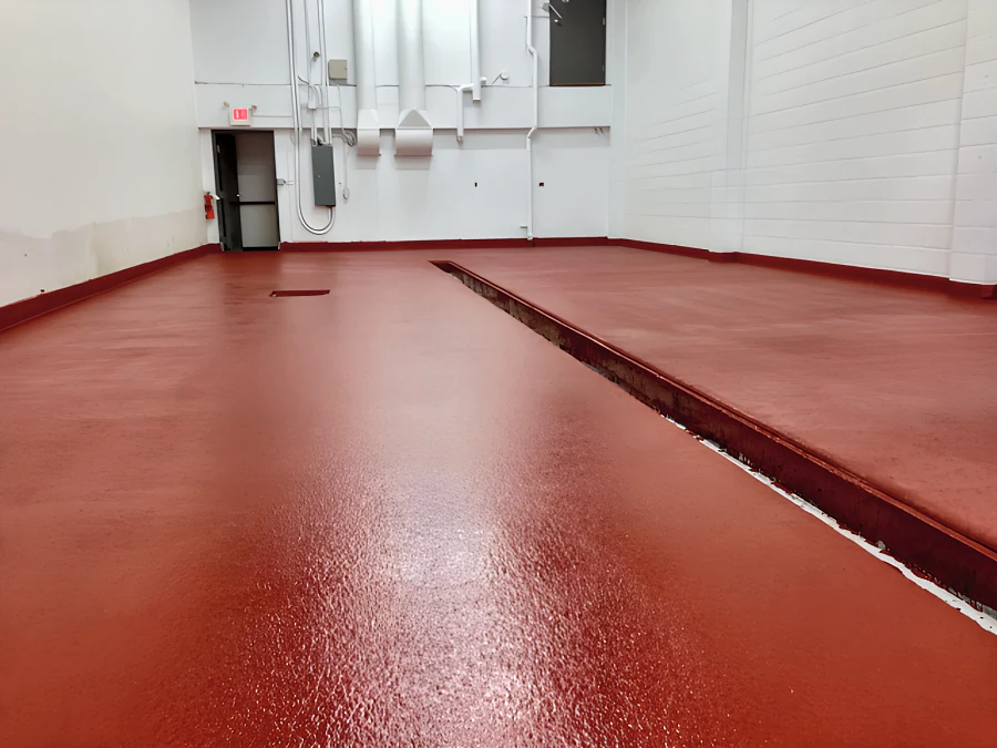 Finished red EWS floor with a textured, slip-resistant surface along the trench drain in the phase 2 room at Parallel 49 Brewing Company
