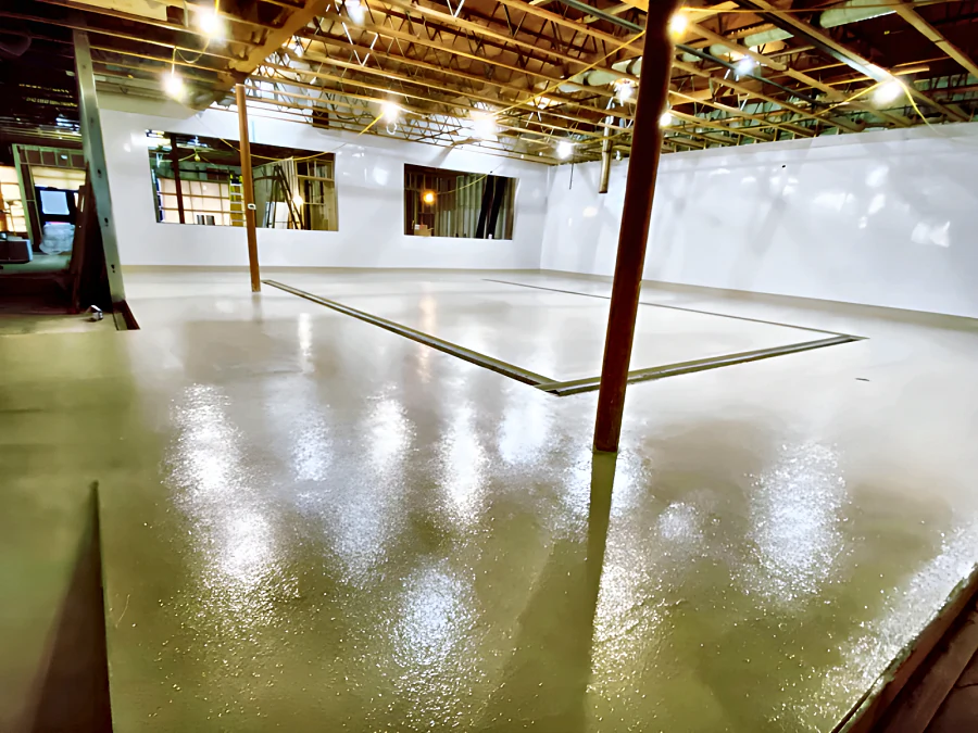 Glossy cementitious urethane floor around a trench drain at Patina Brewery