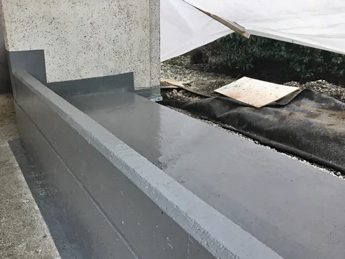 ResinTech FPU and PPM, the products in an RMS roof, coated over a planter up to the building wall