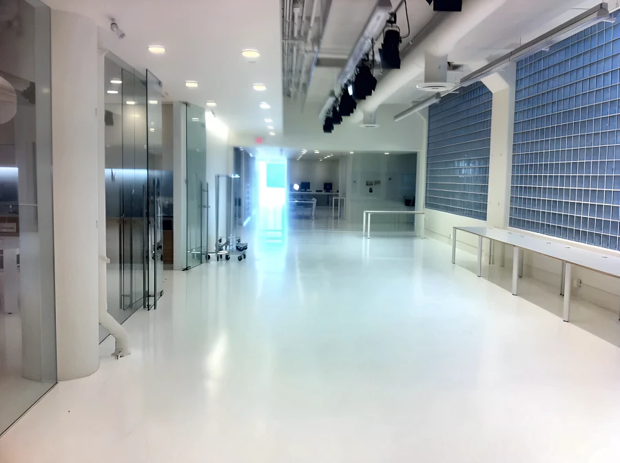 Seamless white resin floor along the glazed corridor at the Aritzia head office