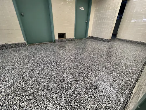 A ResinTech EWS flake floor across the room to the doorway, with a coved flake base