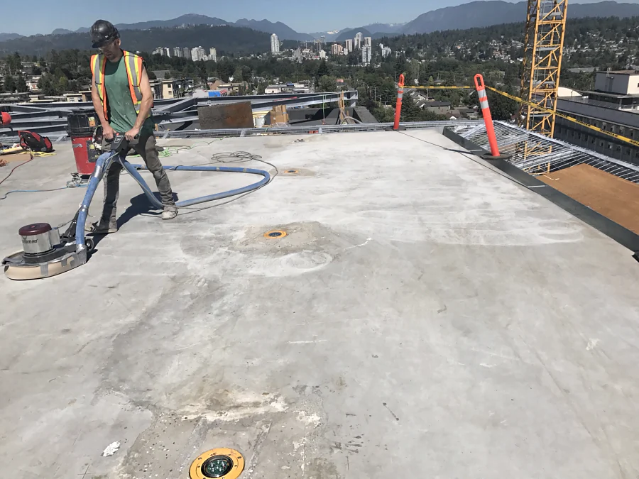 Grinding the concrete helipad deck at Royal Columbian Hospital in New Westminster under dust extraction, before the traffic coating