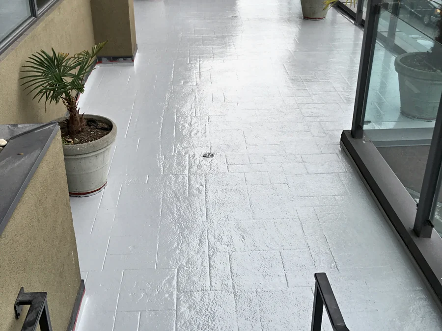 The length of the Moxies patio at the Sandman Hotel West Georgia in grey traffic coating, from the stairs to the far end of the terrace