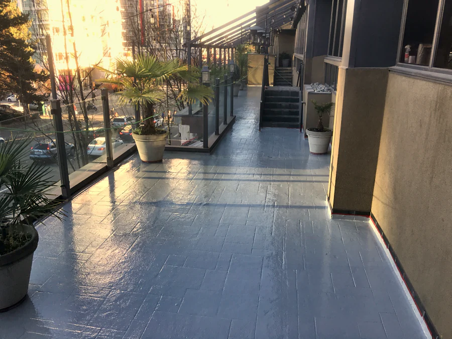 The Moxies patio at the Sandman Hotel on West Georgia Street, Vancouver, finished in a glossy grey traffic coating over the patterned deck