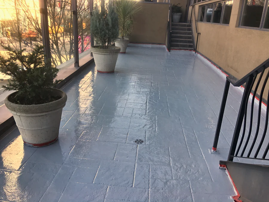 Finished grey traffic coating round a drain and the planter bases on the Moxies patio at the Sandman Hotel West Georgia