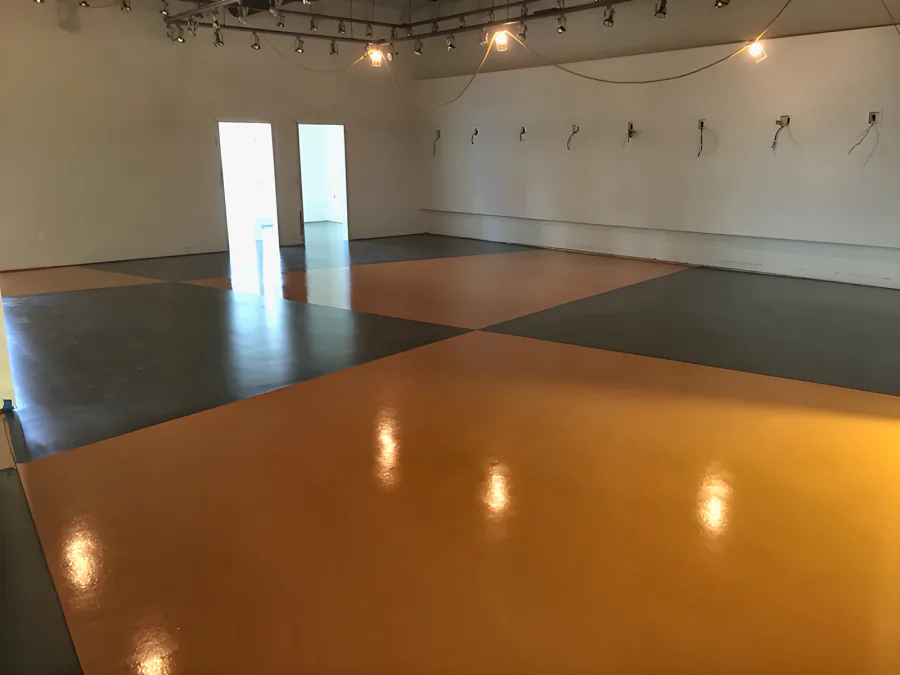 Finished orange and charcoal urethane sections across a showroom floor