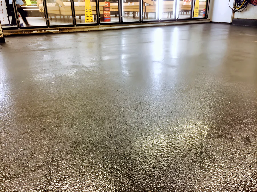 Textured grey epoxy floor running up to the cooler doors in the milk walk-in cooler at the Real Canadian Superstore in Surrey