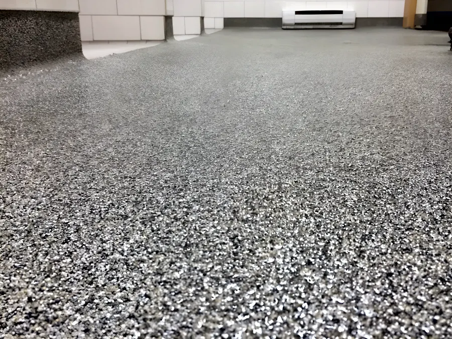 The decorative quartz floor run the length of a school washroom in Surrey