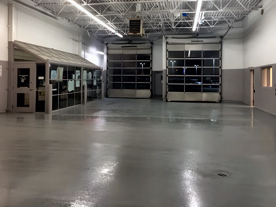Finished grey traffic coating across the service drive of a Toyota dealership at the Richmond Auto Mall, from the service office to the roll-up doors