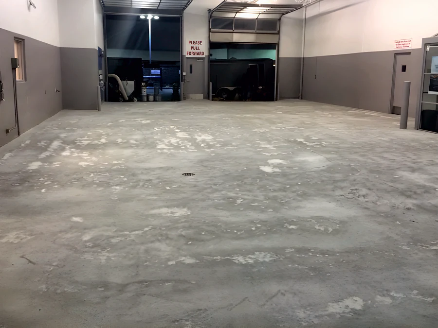 The bare, prepared concrete slab of a Toyota dealership service drive at the Richmond Auto Mall, before coating
