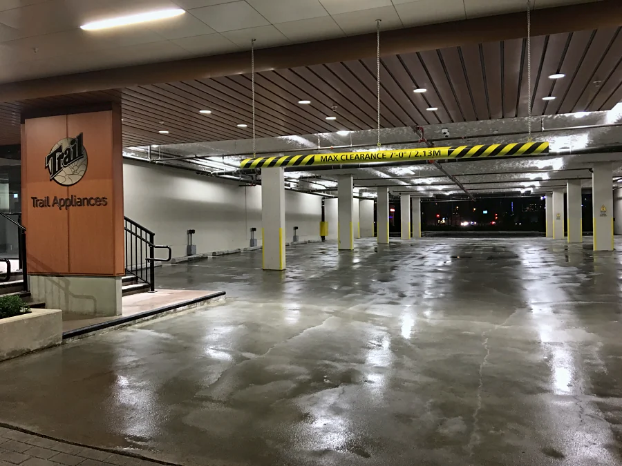 The parkade under the Trail Appliances store in Richmond after shot blasting, the floor wet under the lights, 2016