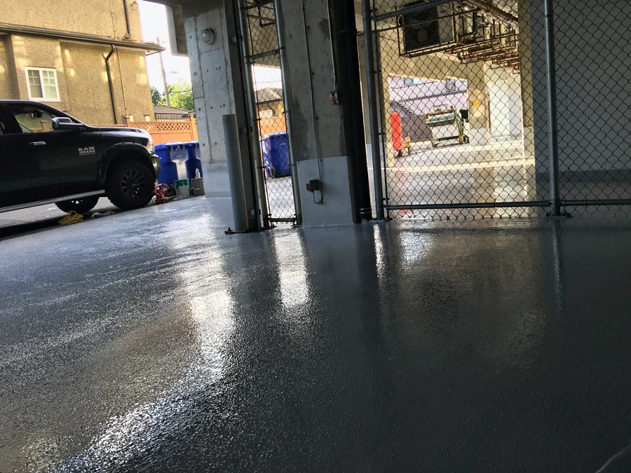 Tremco Vulkem 350NF/346 traffic coating laid round a column and the posts of a garbage enclosure in Vancouver