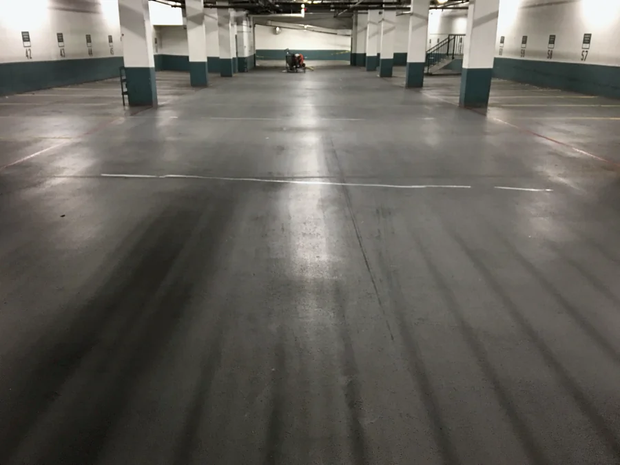 The drive aisle of a residential building parkade in Vancouver after shot blasting, ready for the top coat over the existing membrane
