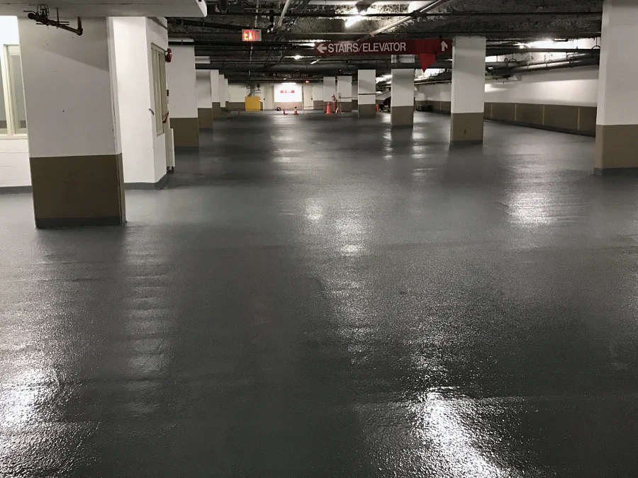 The new grey coat round the columns of the Whole Foods parkade in Vancouver, glossy under the lights