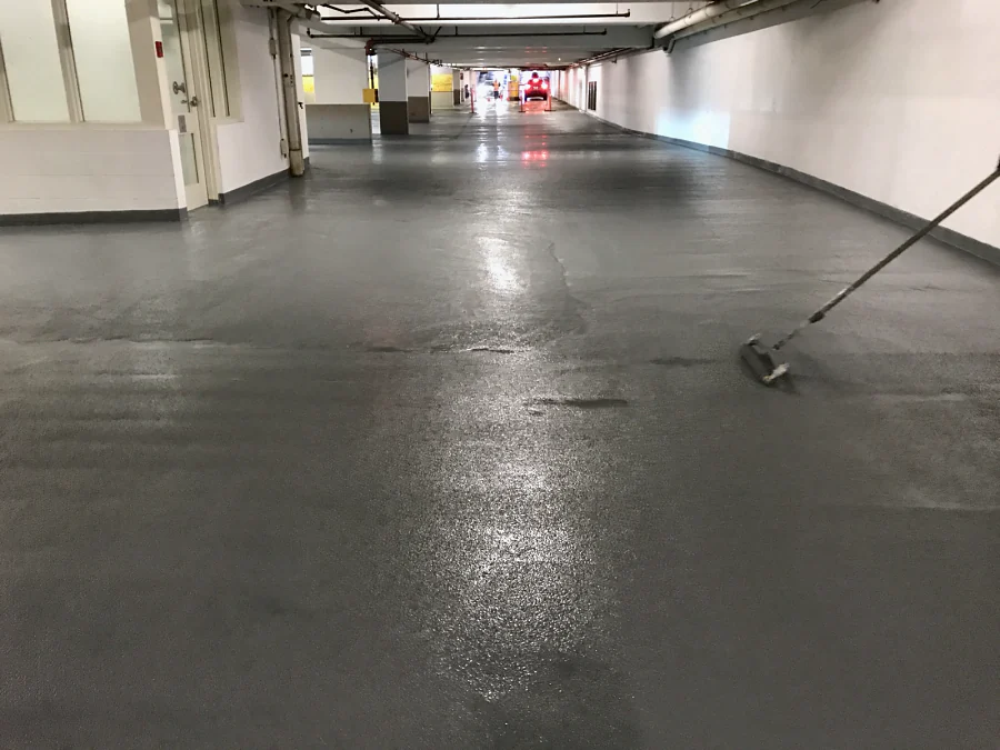 The Whole Foods parkade in Vancouver recoated in grey down the drive aisle, the new coat still wet